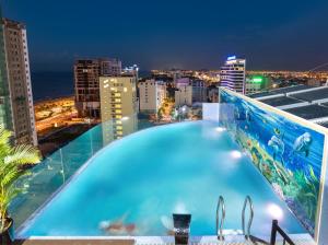a swimming pool on the roof of a building at night at Nhat Minh Hotel and Apartment in Da Nang
