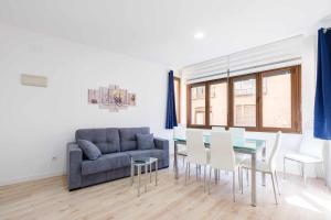 a living room with a couch and a table and chairs at El Mirador de la Catedral by Toledo AP in Toledo