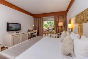 a hotel room with a large bed and a television at Best Western Premier Bangtao Beach Resort & Spa in Bang Tao Beach