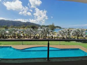 een uitzicht vanaf het balkon van een resort met een zwembad bij Rustic one bedroom unit for 4 pax with Sea View by JoMy Homestay in Lumut