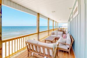 a balcony with chairs and a view of the ocean at On Deck in Dauphin Island