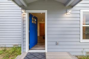 a blue door on a white house at New Home- Minutes from Beach Foosball & Yard in Fort Bragg