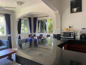 a kitchen with a glass counter top in a room at Royal Palms Apartment A4 in Mombasa