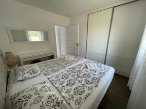 a bedroom with a bed with a black and white blanket at Vila Softic Amra in Umag +40 photos