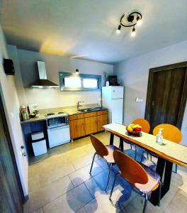 a kitchen with a table and chairs in a room at Etoile apartment in Perissa