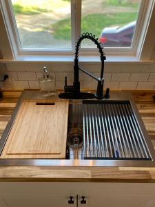 a kitchen counter with a sink and a sink at The Arkansas Tiny House in Mulberry