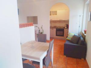 a dining room and kitchen with a table and a couch at Holiday home in Asti with a lovely hill view from the garden in Moncucco Torinese