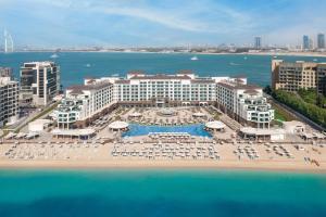 an aerial view of a resort with chairs and umbrellas at Taj Exotica Resort & Spa, The Palm, Dubai in Dubai