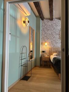 a bedroom with a bed and a mirror at Hôtel Le Blason in Amboise