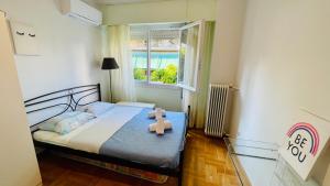 una piccola camera da letto con un orsacchiotto seduto su un letto di 70m2 apartment 4 mins from Athens central station! ad Atene