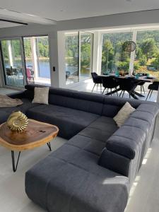 a living room with a couch and a table at Apartments Saaldorf-Ferienhaus mit 6 separaten Apartments 45qm-120qm in Bad Lobenstein
