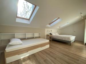 a bedroom with two beds and a window at Słoneczny Taras i Morska Bryza in Rowy