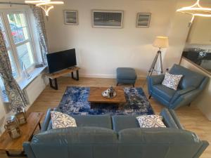 a living room with a couch and a table at Beachcomber in Garlieston