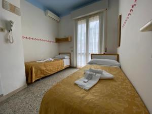 Posteľ alebo postele v izbe v ubytovaní Hotel Nanni Garnì