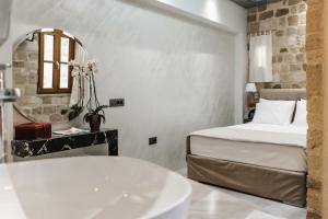 a bathroom with a bed and a tub and a sink at Chateau Anax Boutique Hotel in Rhodes Town