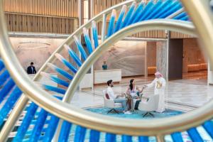 a group of people sitting at a table in a building at Taj Exotica Resort & Spa, The Palm, Dubai in Dubai