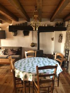 a dining room with a table and a stove at Secheras: House / Villa - Sècheras in Sécheras