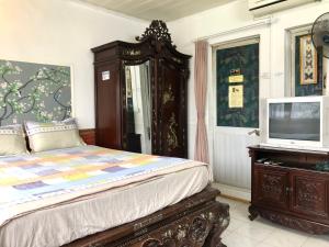 a bedroom with a bed and a tv on a dresser at North Hostel N.2 in Hanoi