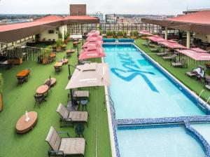an overhead view of a hotel pool with tables and chairs at Verona Hotel and Conference Center in Ruiru