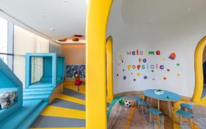 a childrens room with a slide and a table at Taj Exotica Resort & Spa, The Palm, Dubai in Dubai