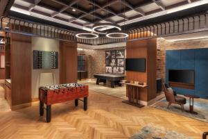 a room with a foosball table and a piano at Taj Exotica Resort & Spa, The Palm, Dubai in Dubai