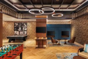 a billiards room with a pool table and a ping pong table at Taj Exotica Resort & Spa, The Palm, Dubai in Dubai