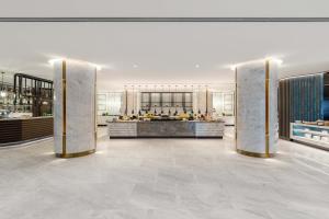 a lobby with two columns in the middle of a building at Taj Exotica Resort & Spa, The Palm, Dubai in Dubai