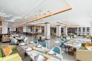 a dining room with tables and chairs at Taj Exotica Resort & Spa, The Palm, Dubai in Dubai