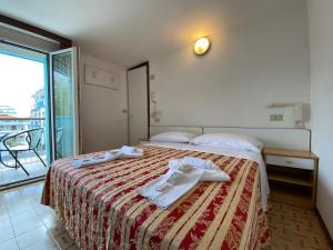 a hotel room with a bed and a balcony at Hotel Nanni Garnì in Rimini