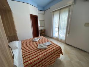 Posteľ alebo postele v izbe v ubytovaní Hotel Nanni Garnì