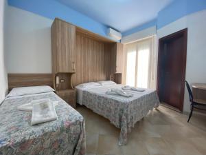 Posteľ alebo postele v izbe v ubytovaní Hotel Nanni Garnì