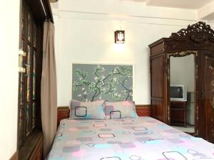 a bedroom with a bed and a mirror at North Hostel N.2 in Hanoi