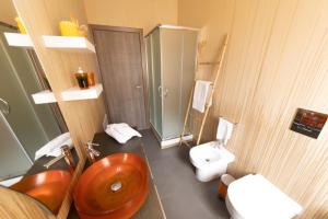 a bathroom with a red sink and a toilet at Stella Maris Case Vacanze in Balestrate +46 photos
