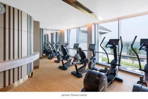 a gym with treadmills and ellipticals in a building at Taj Exotica Resort & Spa, The Palm, Dubai in Dubai