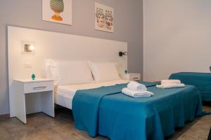 a hotel room with a bed with a blue blanket at La Querencia in Palermo