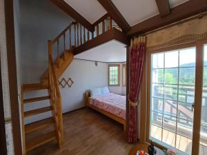 a bedroom with a bunk bed and a staircase at Beljari Pension in Tongyeong +69 photos