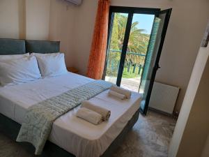 een slaapkamer met een groot bed met twee handdoeken erop bij PALMAR CLUB - Villa EMMANUELA in Marathón +79 foto's