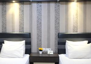 Grand Krakatau Hotel Serang tesisinde bir odada yatak veya yataklar