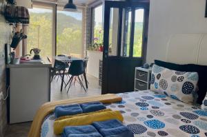 a bedroom with a bed and a kitchen with a table at Apartman Verona in Buzet