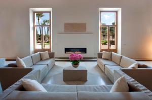 a living room with couches and a fireplace at Fontsanta Hotel Thermal & Spa - Adults Only in Colònia de Sant Jordi