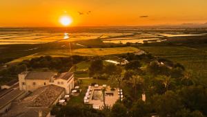 an aerial view of a house with the sunset in the background at Fontsanta Hotel Thermal & Spa - Adults Only in Colònia de Sant Jordi