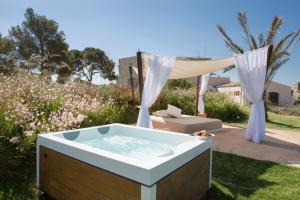 a hot tub in a yard with a tent at Fontsanta Hotel Thermal & Spa - Adults Only in Colònia de Sant Jordi