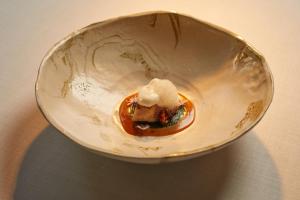 a bowl with food in it on a table at Fontsanta Hotel Thermal & Spa - Adults Only in Colònia de Sant Jordi
