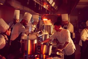 a group of chefs in a kitchen preparing food at Fontsanta Hotel Thermal & Spa - Adults Only in Colònia de Sant Jordi