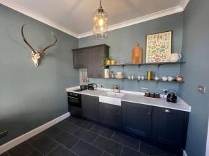 a kitchen with a sink and a counter at The Old Shop, A Two Bed Flat in Inverkip Village in Inverkip