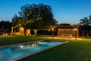 a backyard with a swimming pool and a house at Can Cristus in Monells