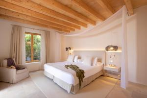 a bedroom with a large white bed and a window at Fontsanta Hotel Thermal & Spa - Adults Only in Colònia de Sant Jordi