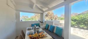 a dining room with a table and blue pillows at Villaggio Camping Oasi in Vieste