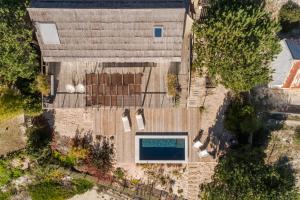 an overhead view of a house with a swimming pool at Precious Cabin in Comporta in Comporta