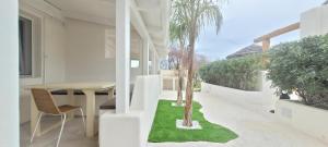 a dining room with a table and chairs and a table and trees at Villaggio Camping Oasi in Vieste